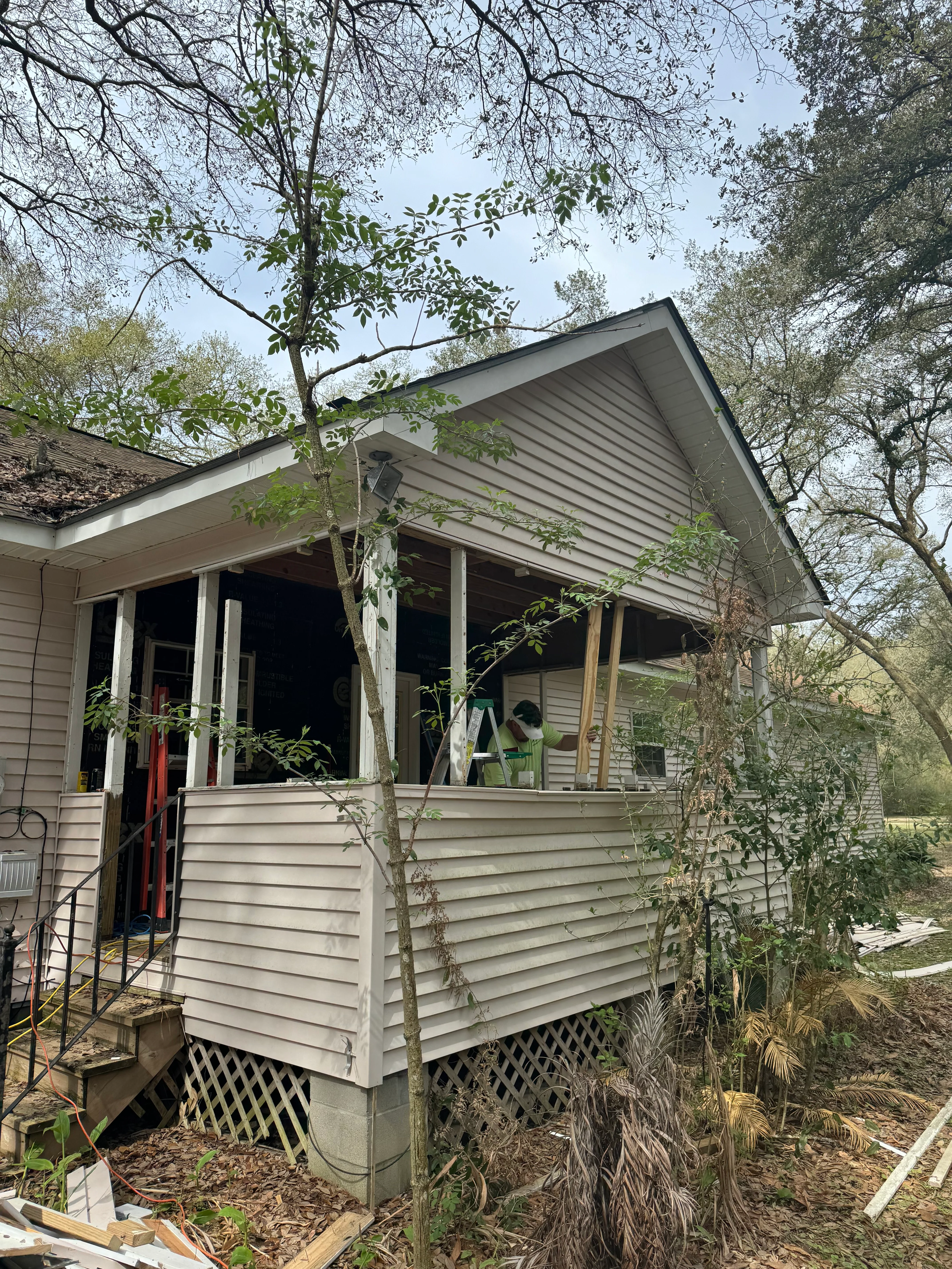 New vinyl-sided residential addition with pitched roof and covered porch entrance