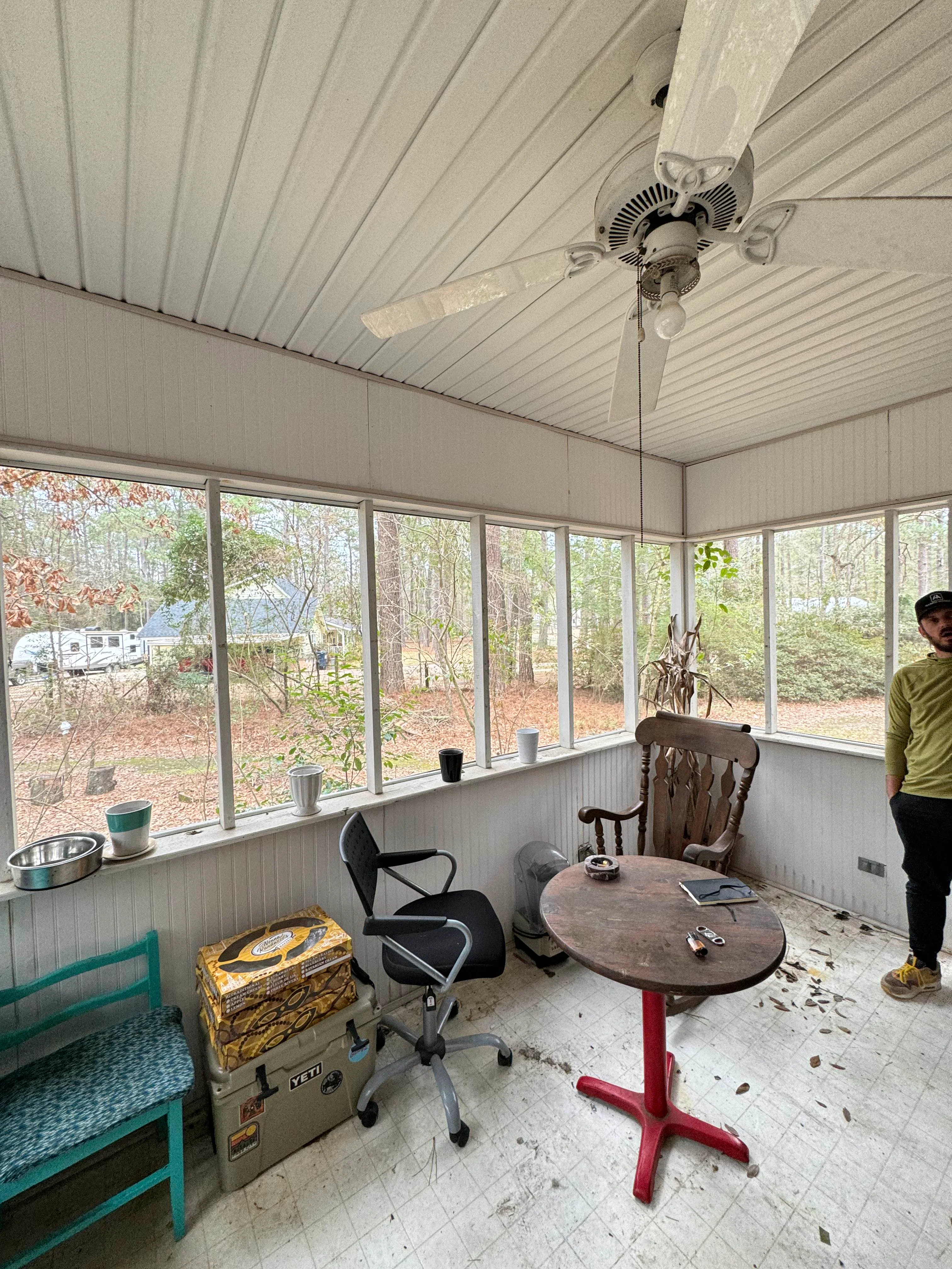 Interior of screened porch with metal roof, screen panels, and finished flooring