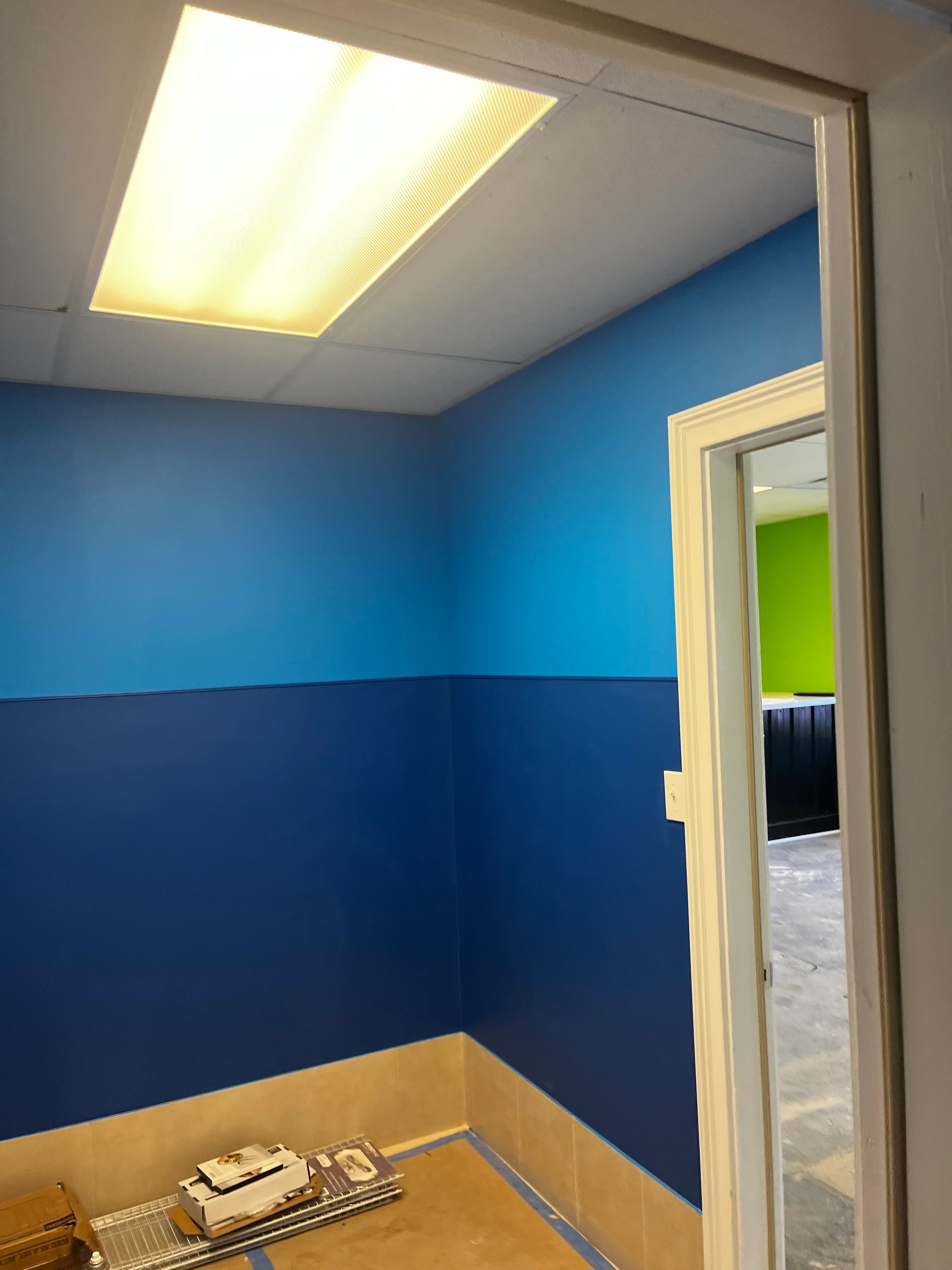 Interior room with two-tone blue painted walls, white trim, and recessed ceiling light fixture