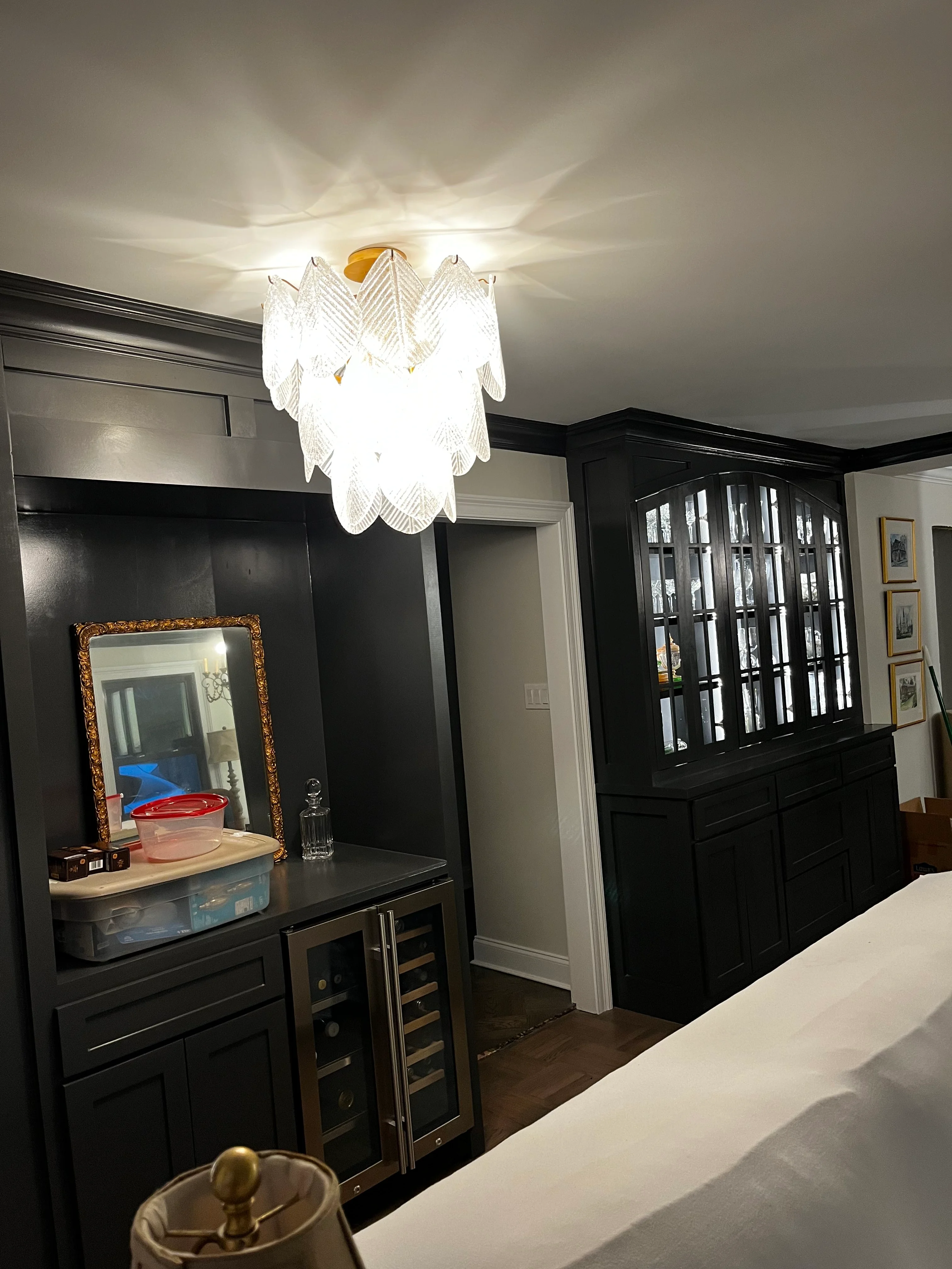 Master bedroom with black cabinetry, vanity mirror, and decorative ceiling light fixture