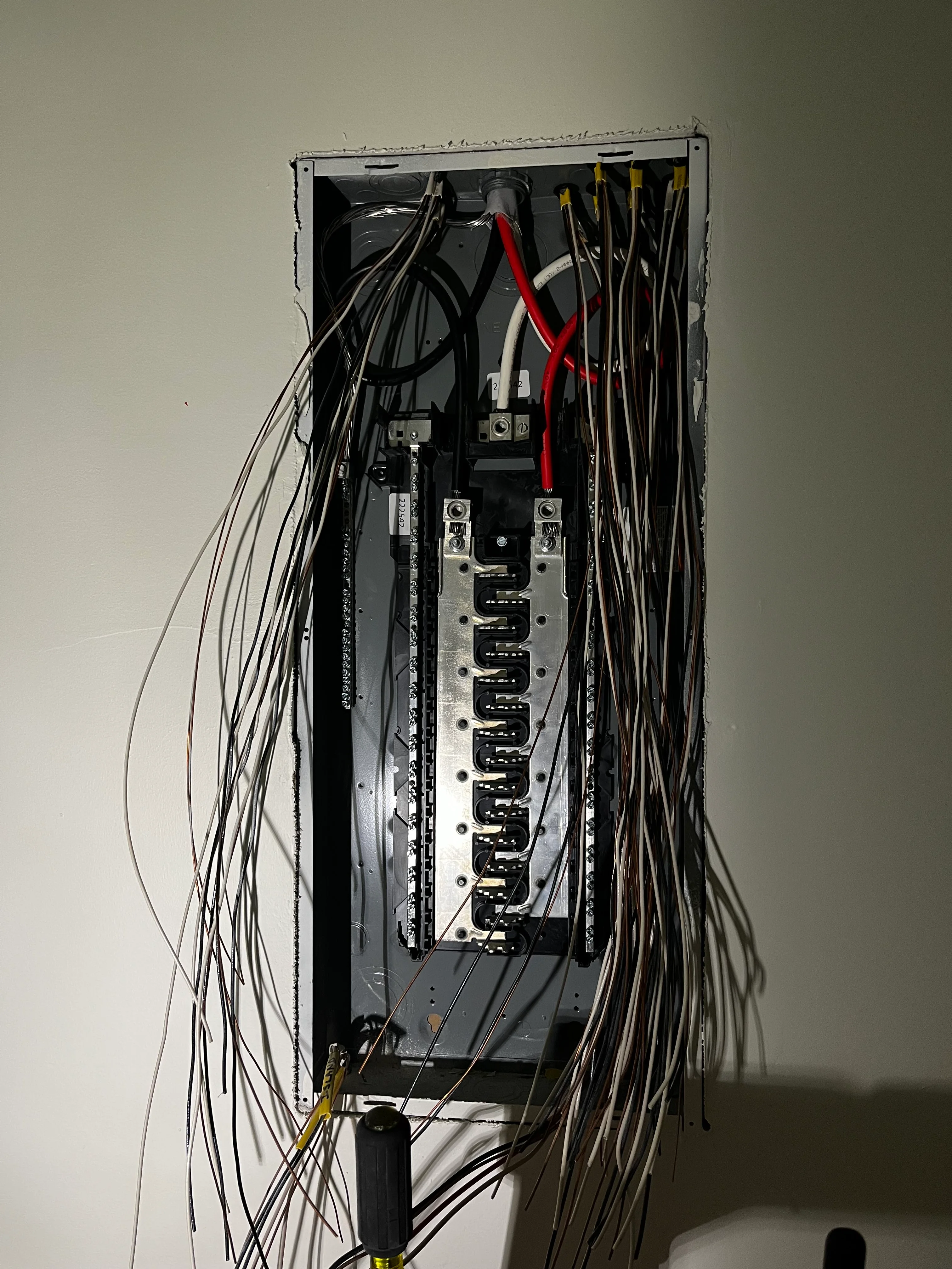 Electrical panel with organized breakers and neatly routed black, white, and red wiring