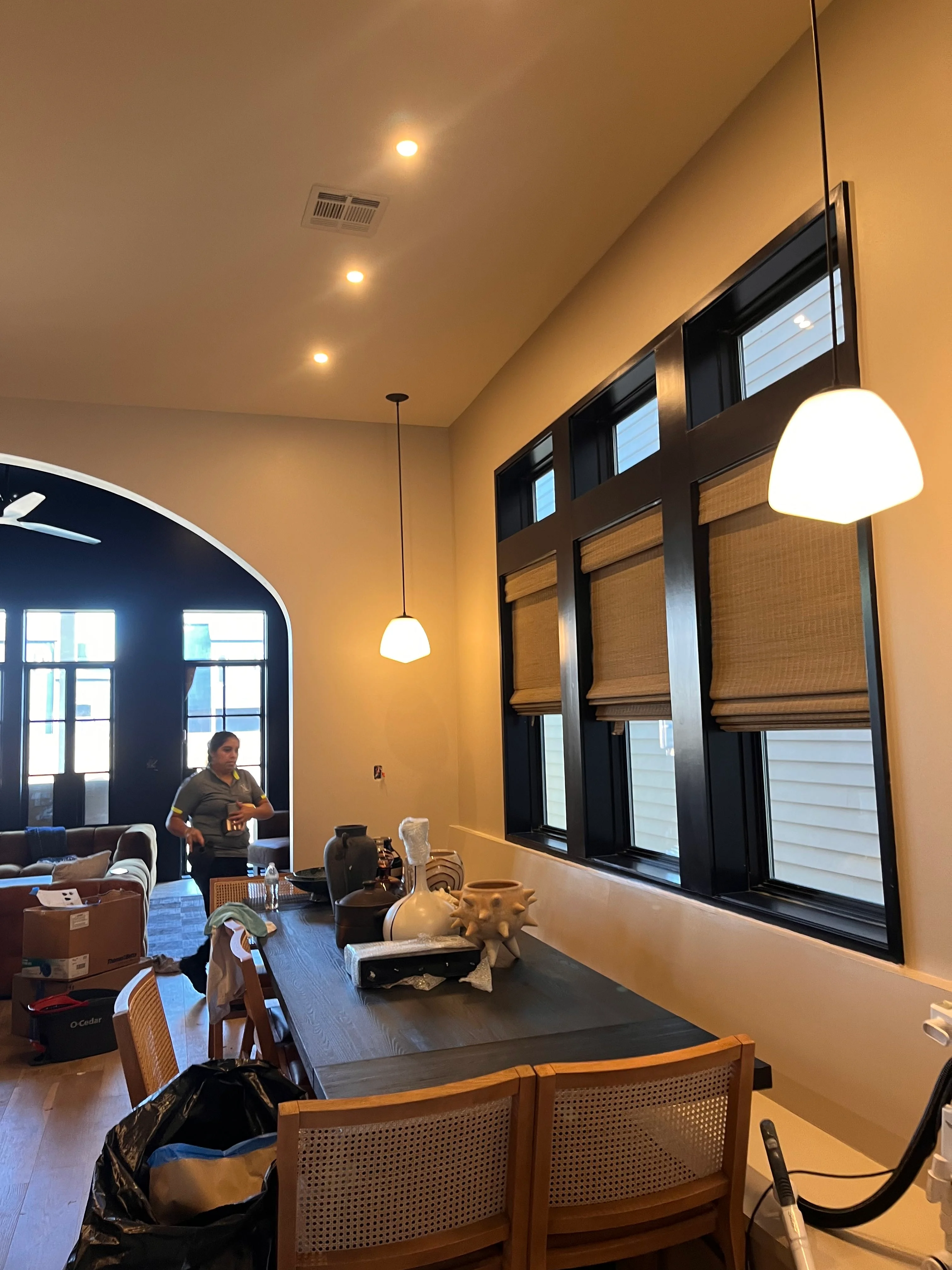 Modern office interior with recessed lighting, black-framed windows, and wood accents