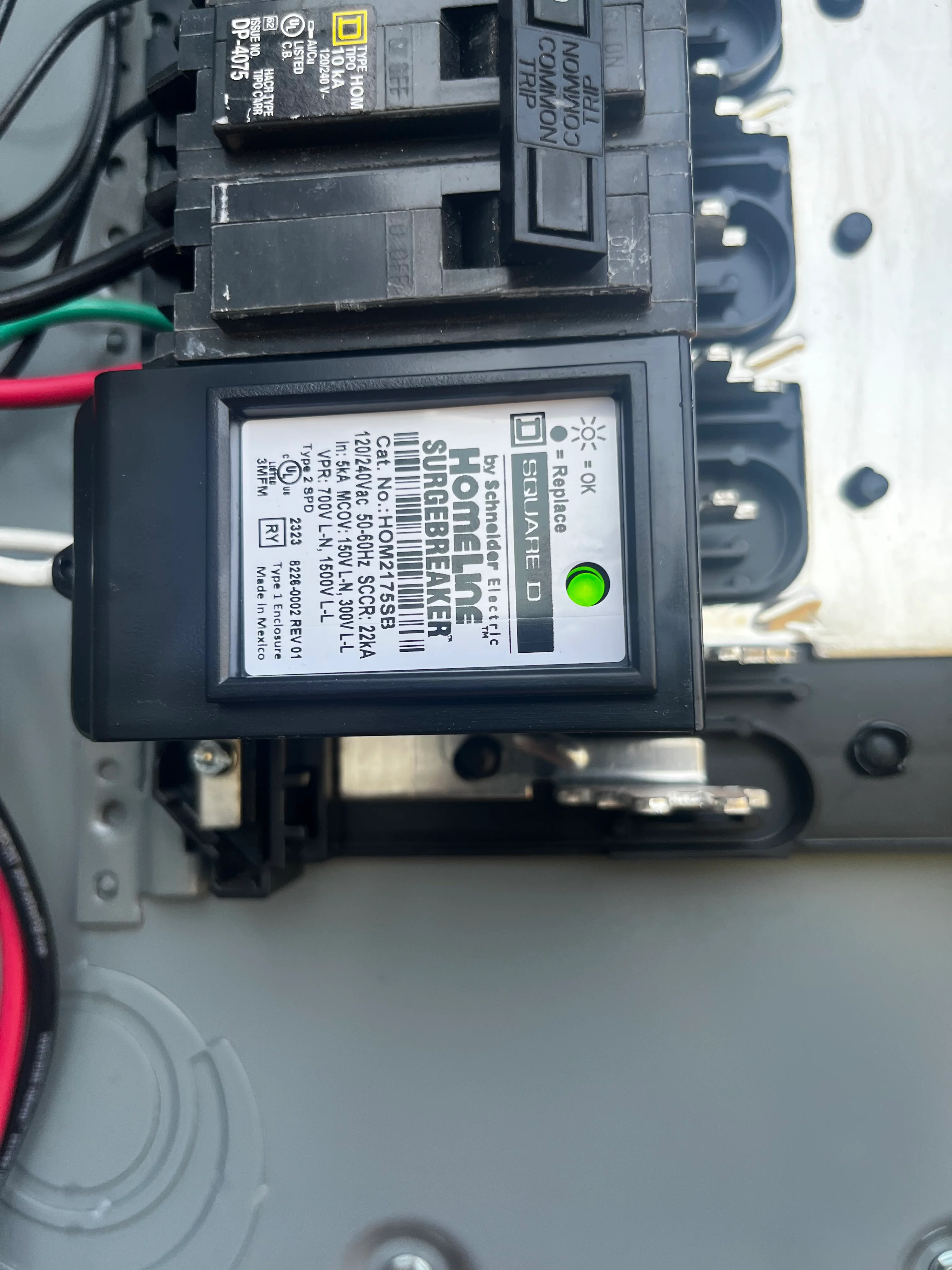 Square D electrical panel with breakers and green status indicator installed