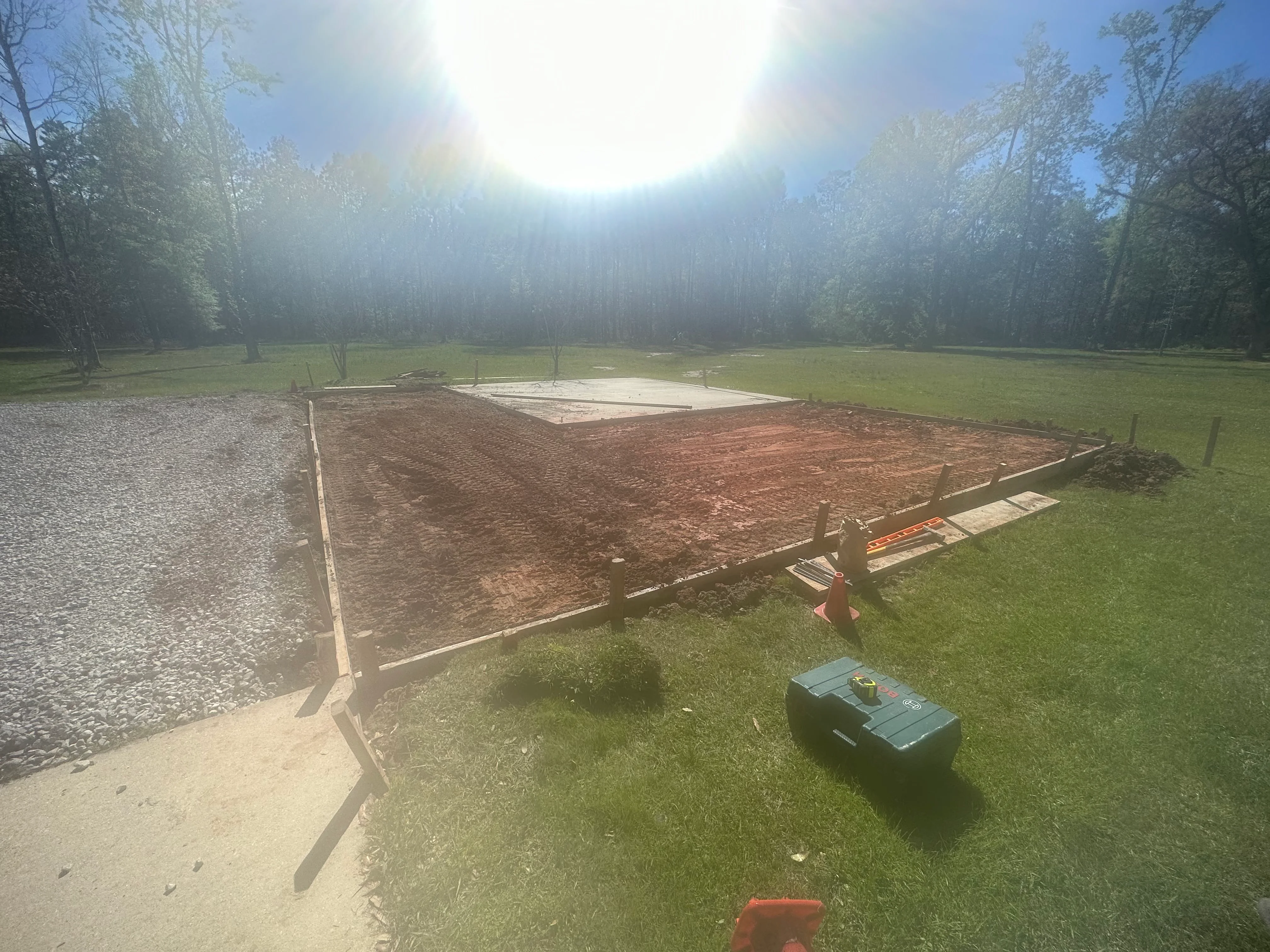 Newly constructed equestrian arena with wooden fencing and tilled riding surface